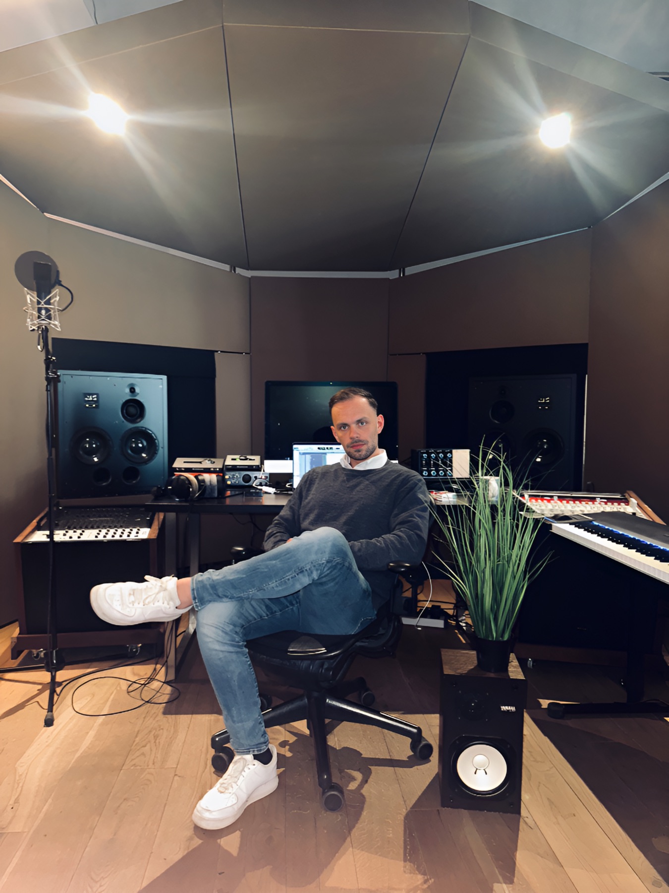 Marc Pueschl seated in his recording studio