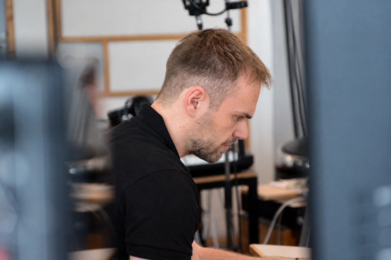 Marc Pueschl at work during a studio session, seen through the studio equipment
