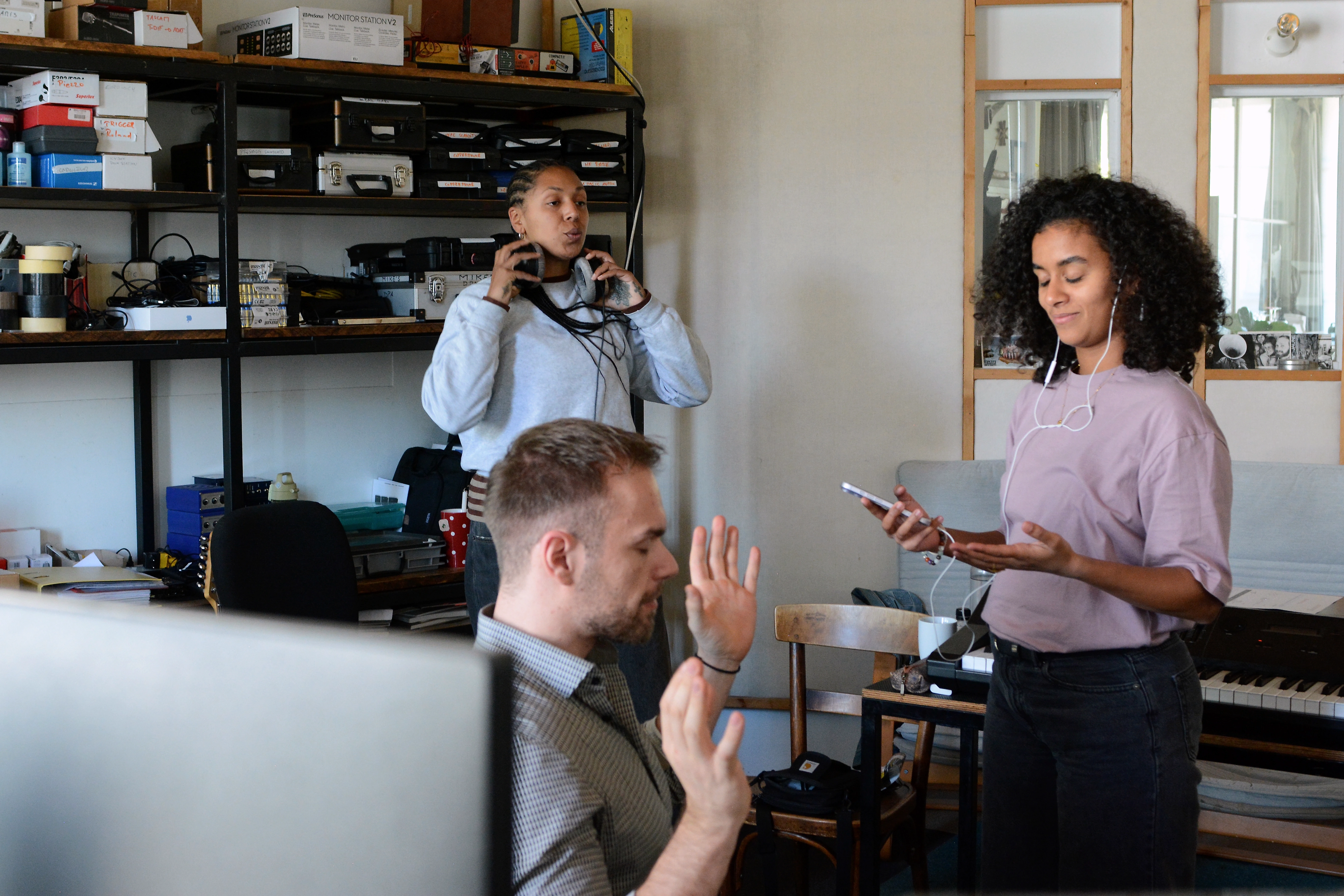 Marc Pueschl working with two collaborators during a studio session